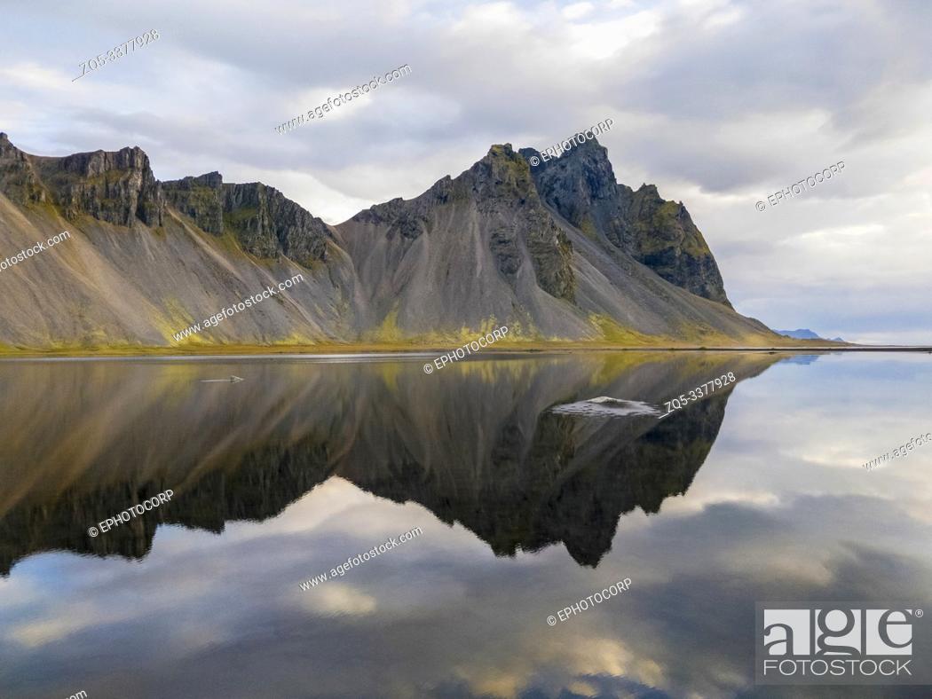 Stock Photo: Mountain reflection at Hofn in Iceland.
