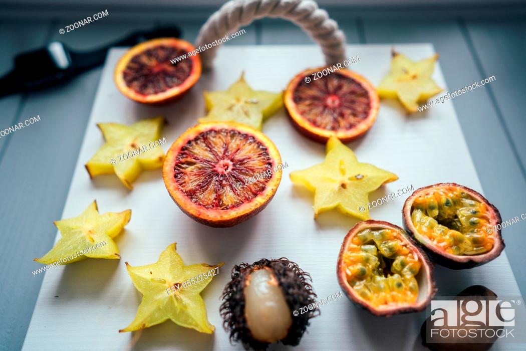 Stock Photo: Exotic fruits on a tray on a light background.