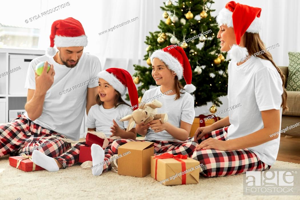 Stock Photo: happy family opening christmas gifts at home.