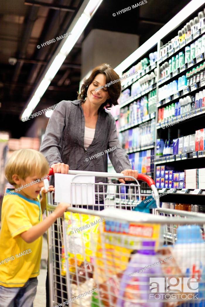 Stock Photo: Woman grocery shopping with son.