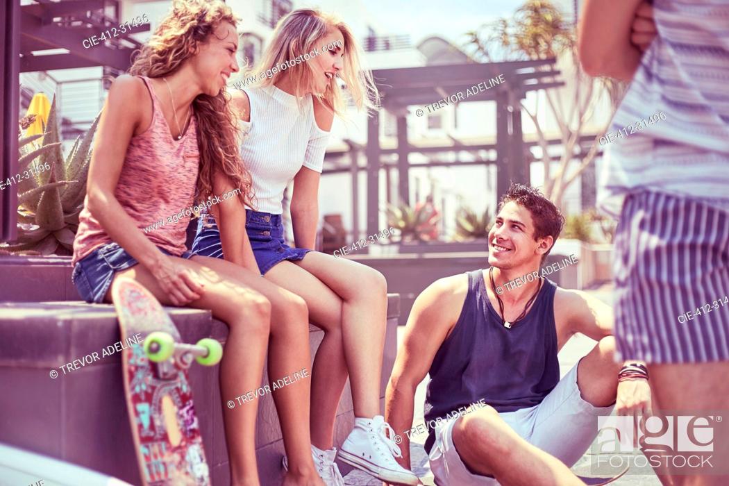 Stock Photo: Friends with skateboard hanging out.
