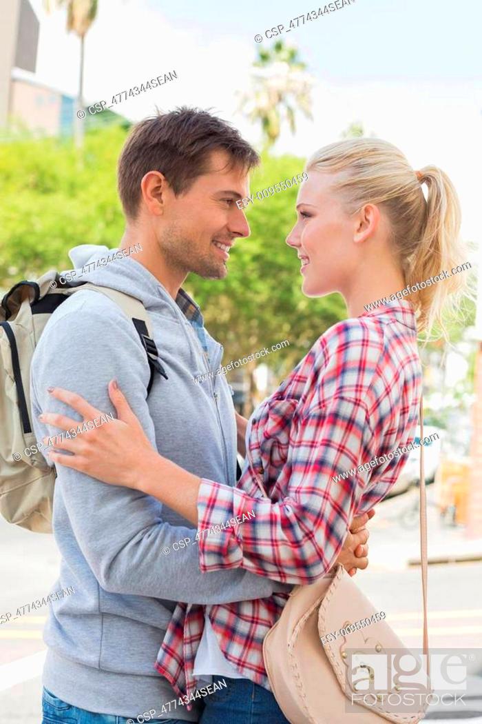 Stock Photo: Young tourist couple hugging each other.