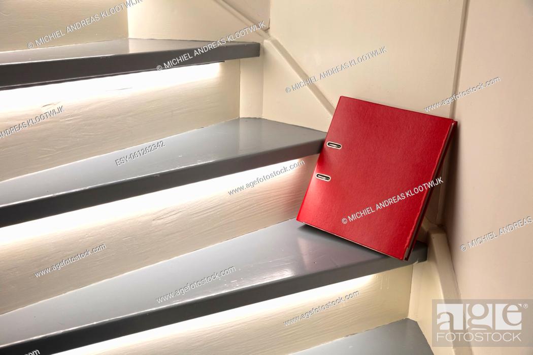 Stock Photo: Red file on the stairs, waiting for someone to pass, selective focus.