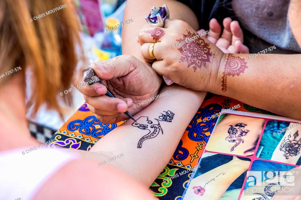 A henna tattoo being applied at the famous Walking Street night market in  Phuket old Town, Phuket, Stock Photo, Picture And Rights Managed Image.  Pic. RHA-1297-576 | agefotostock