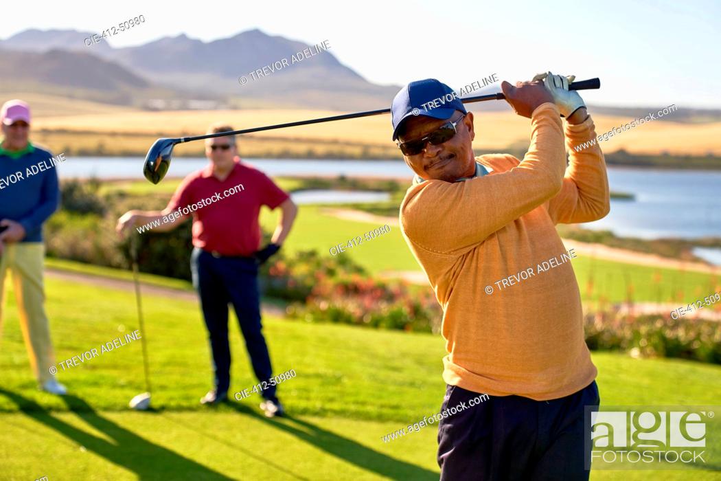 Stock Photo: Mature male golfer teeing off at sunny box.