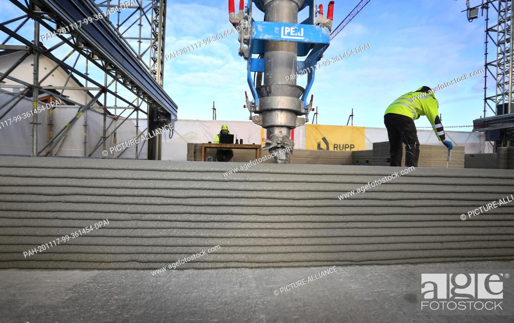 Stock Photo: 17 November 2020, Bavaria, Weißenhorn: Walls are built in layers on the first floor of a building shell using a 3D concrete printer.
