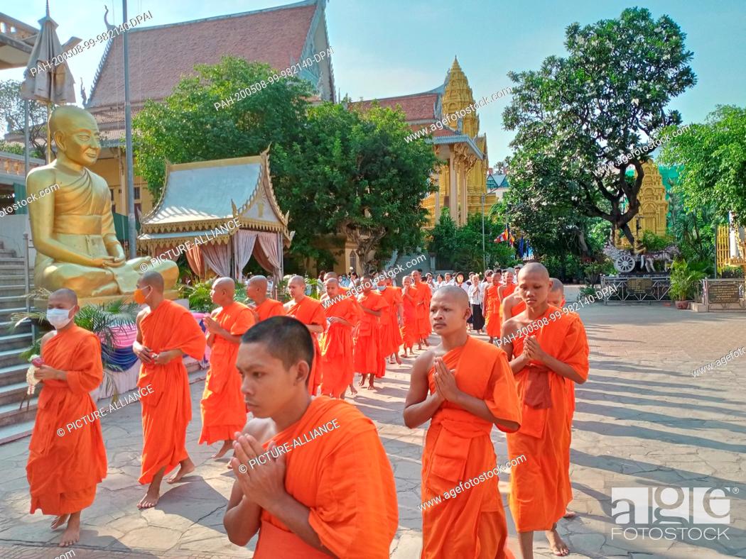 Imagen: 06 May 2020, Cambodia, Phnom Penh: Buddhist monks line up with laymen in the temple complex Wat Ounalom to celebrate the Visakha Bucha, the Buddha Day.