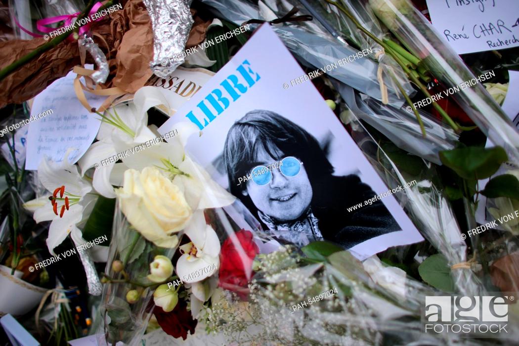 Stock Photo: People have laid down ballpoints, pens, flowers, candles and pictures close to the offices of the satirical magazine 'Charlie Hebdo' in Paris, France.