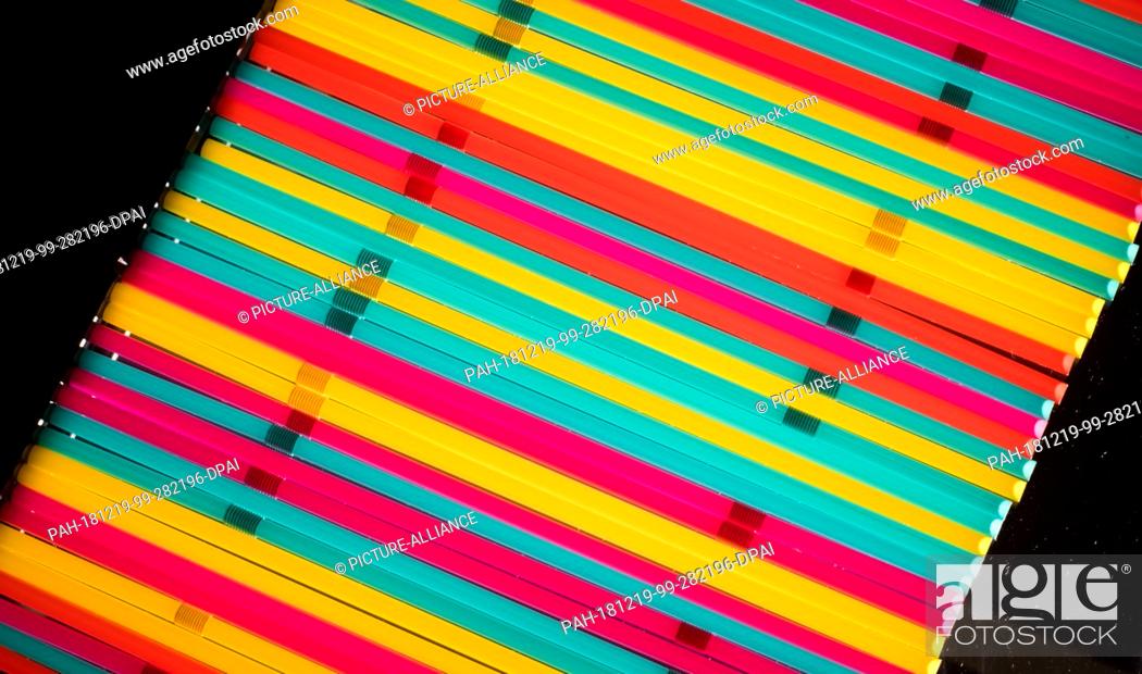 Stock Photo: 19 December 2018, Lower Saxony, Hannover: Plastic drinking straws lie on a table. Drinking straws and other disposable plastic products are to be banned in.