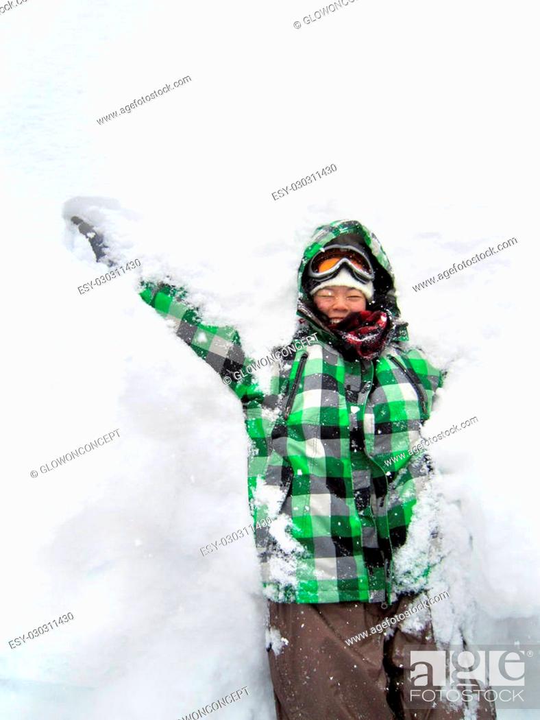 Stock Photo: girl having fun with snow, doing snow angel.