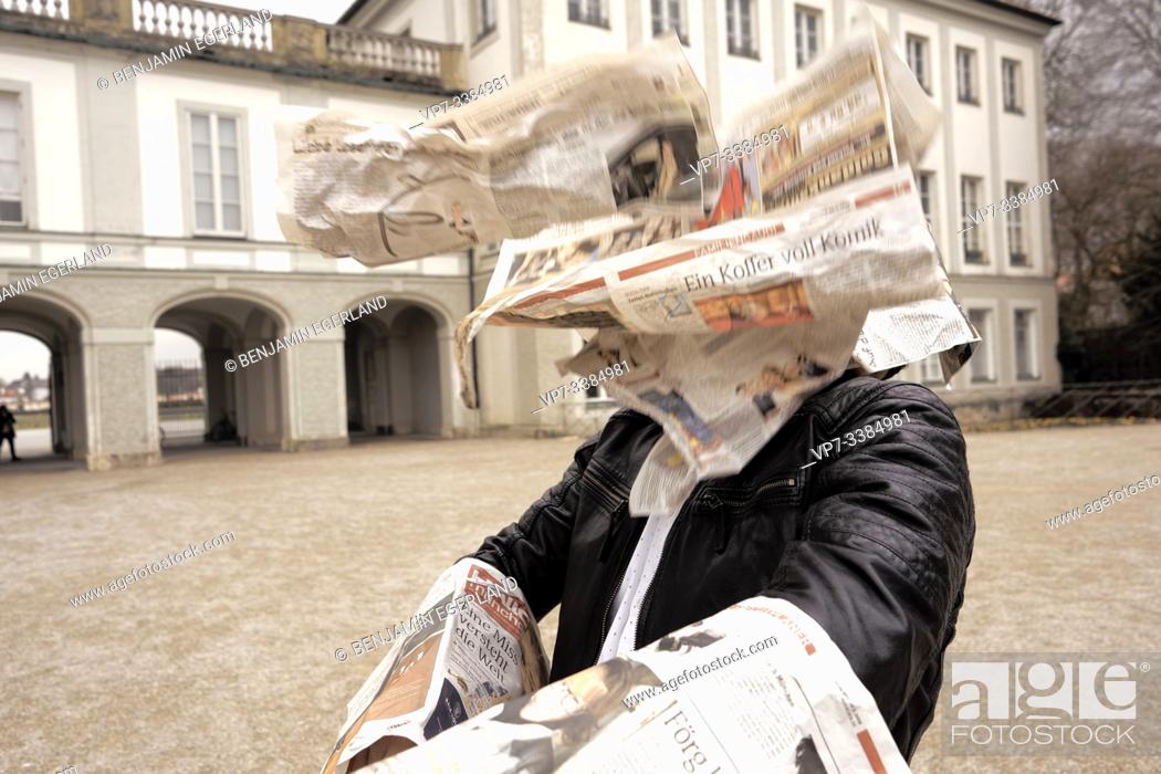 Stock Photo: Man assailed by flying newspapers, in Munich, Germany.
