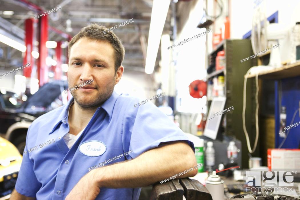 Stock Photo: Portrait of a smiling Caucasian male mechanic in an auto repair shop.