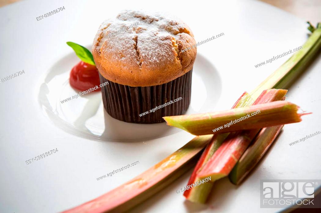Stock Photo: Rhubarb and ginger muffins on white plate.