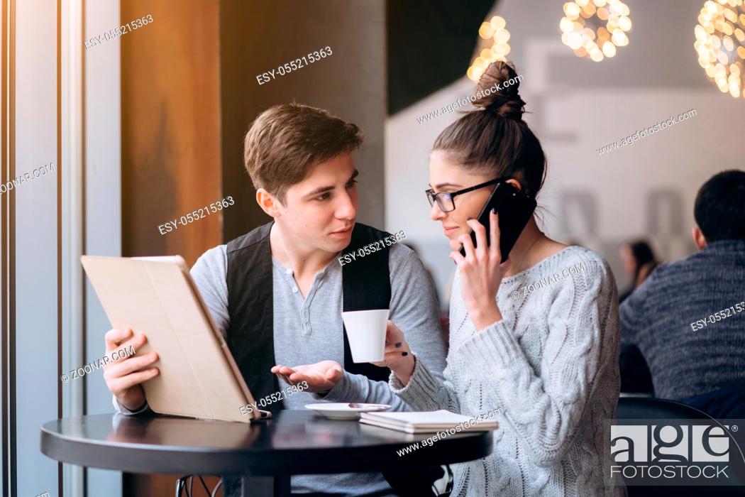 Stock Photo: Guy and girl at a business meeting in a cafe.