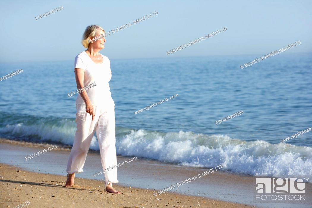 Photo de stock: Senior Woman Enjoying Beach Holiday.