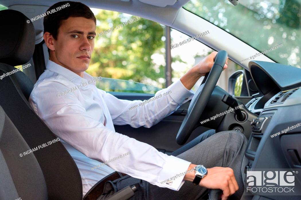 Stock Photo: The young man behind the wheel driving car.