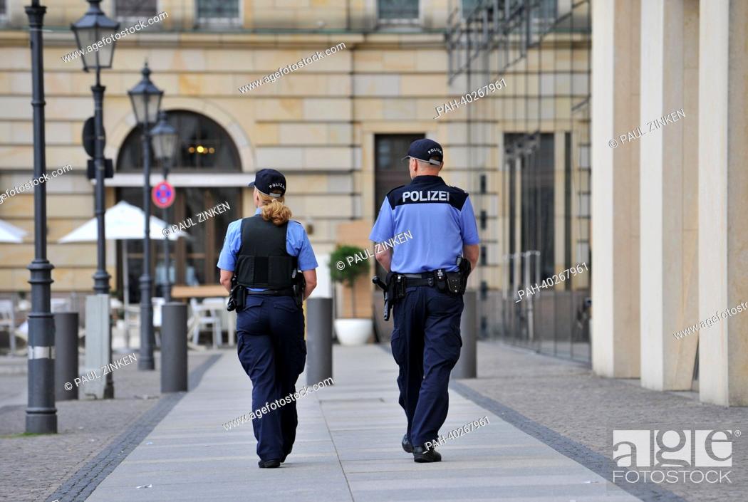 Stock Photo: Police officers patrol at Pariser Platz in Berlin, Germany, 15 June 2013. US President Obama is going to deliver a speech there in front of invited guests on 19.