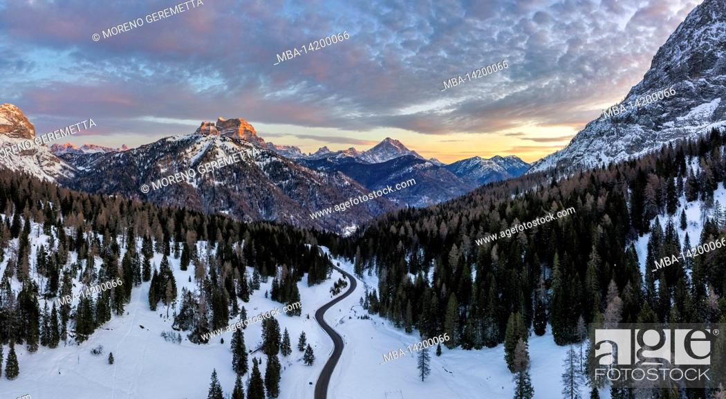 Stock Photo: Italy, Veneto, Belluno, La Valle Agordina, aerial view of the Duran pass, in the background the Mount Pelmo and the Antelao at dawn in winter, Dolomites.