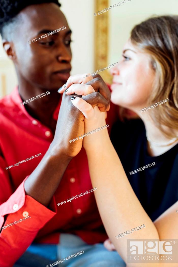 Stock Photo: Happy couple holding hands at home.