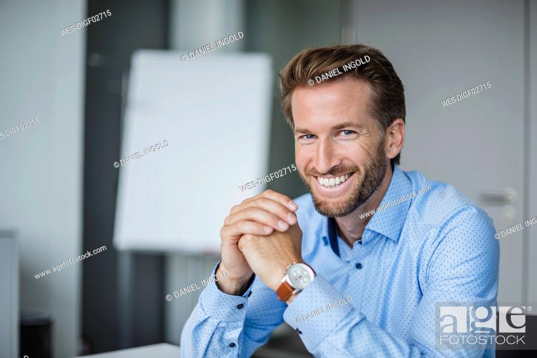 Stock Photo: Portrait of laughing businessman in the office.