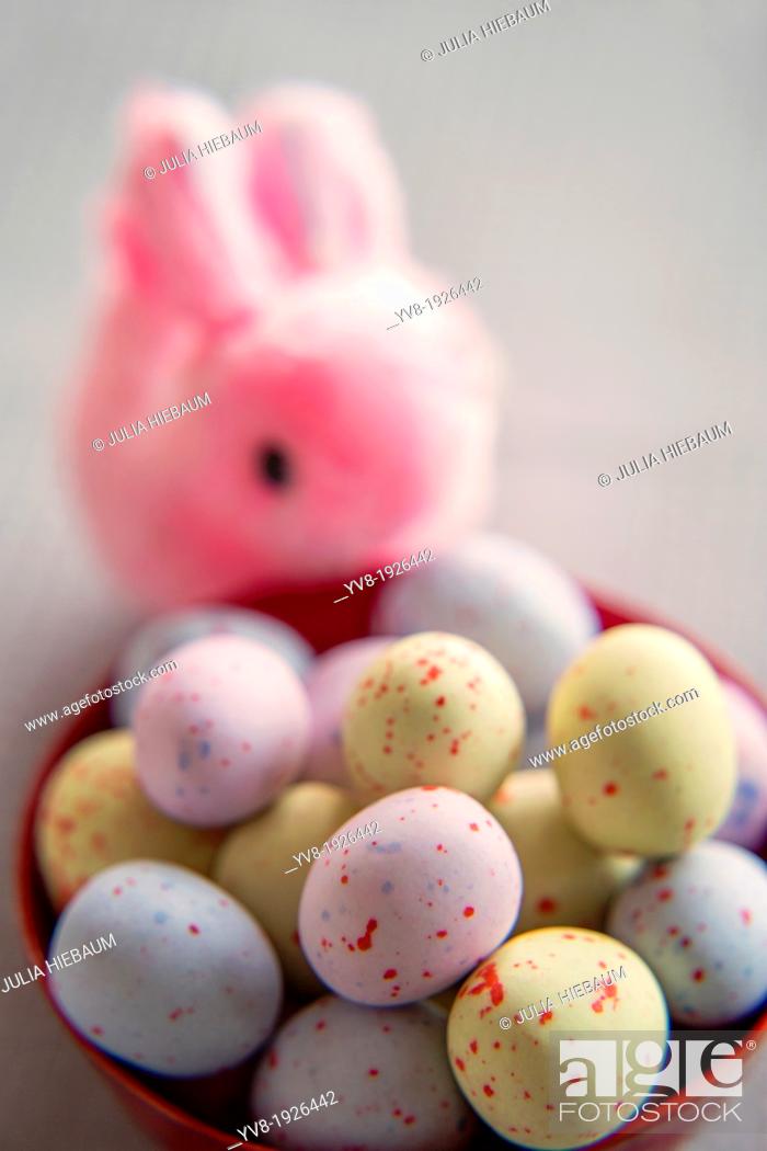 Stock Photo: Pink bunny with colorful easter eggs.
