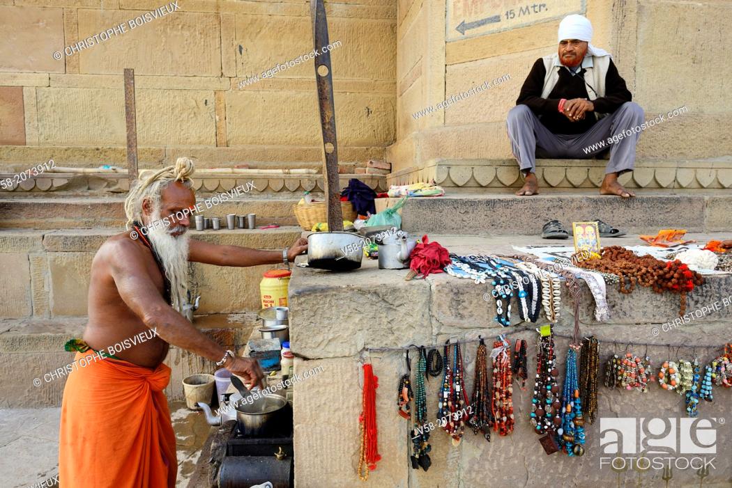 Stock Photo: India, Uttar Pradesh, Varanasi, ""Chai Baba"", Sadhu (ascetic) making a living in preparing tea for the passer bys.