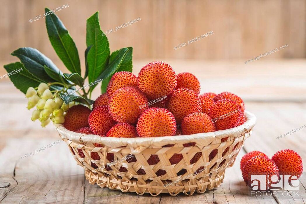 Stock Photo: Basket with ripe arbutus unedo fruits.