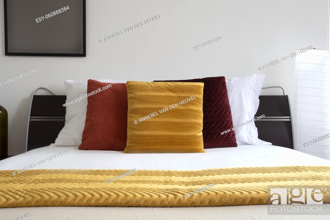 Stock Photo: made bed. Modern and Neat Bed at Night. Elegant double bed. close-up of a made-up bedroom in a hotel room. bed covered with white sheets and pillows.