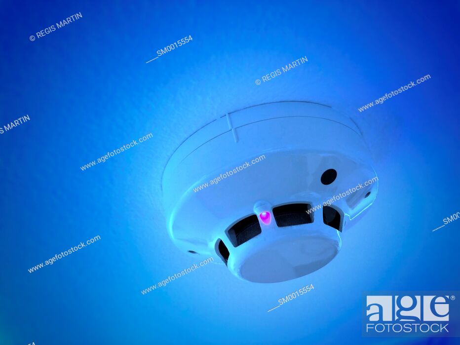 Stock Photo: Smoke detector with blue filter.