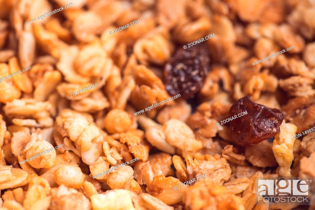 Stock Photo: Useful and tasty muesli with nuts, rasins and flakes. Selective focus macro shot with very shallow depth of field. Healthy and vegetarian lifestyle.