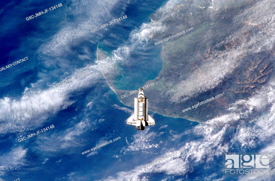 Stock Photo: The Space Shuttle Endeavour is backdropped over the Tasman Sea and Golden Bay of New Zealand's South Island as it approaches the International Space Station.