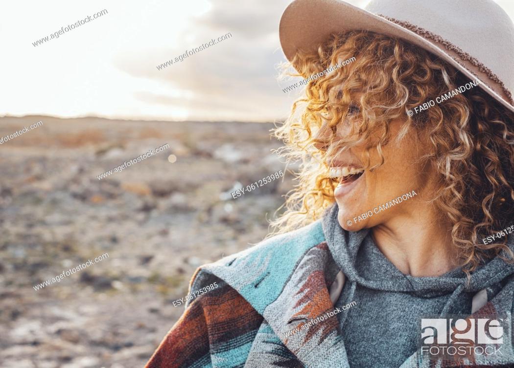 Stock Photo: Side portrait of overjoyed and excited cheerful pretty woman with curly blonde hair and hat have fun in outdoor travel leisure activity.