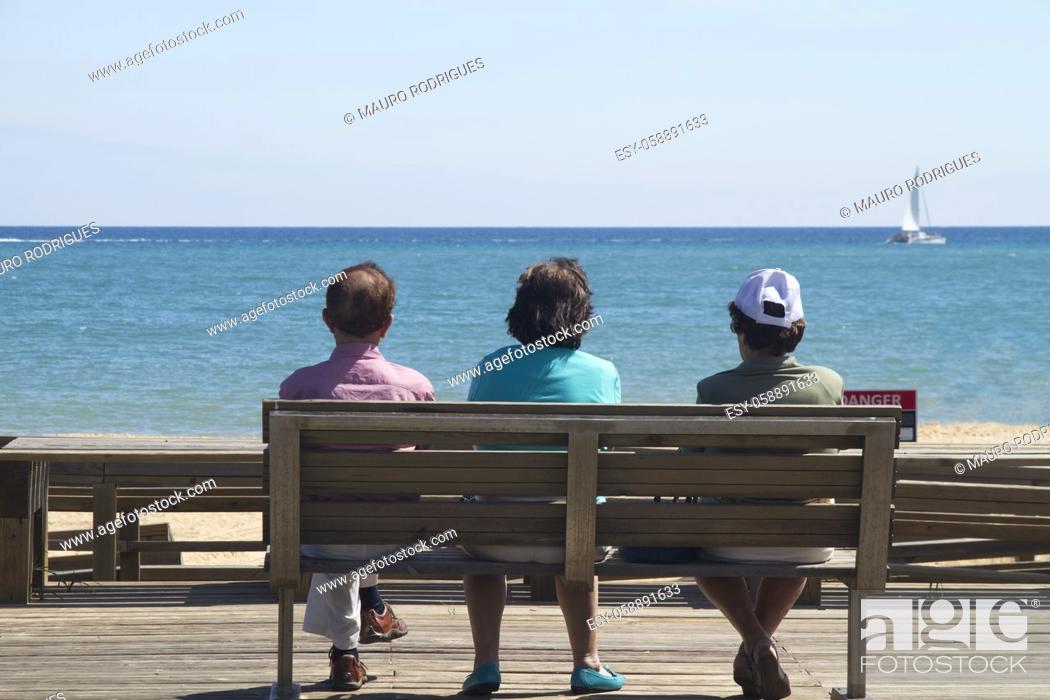 Stock Photo: View of the older women relaxing on a bench watching the sea.