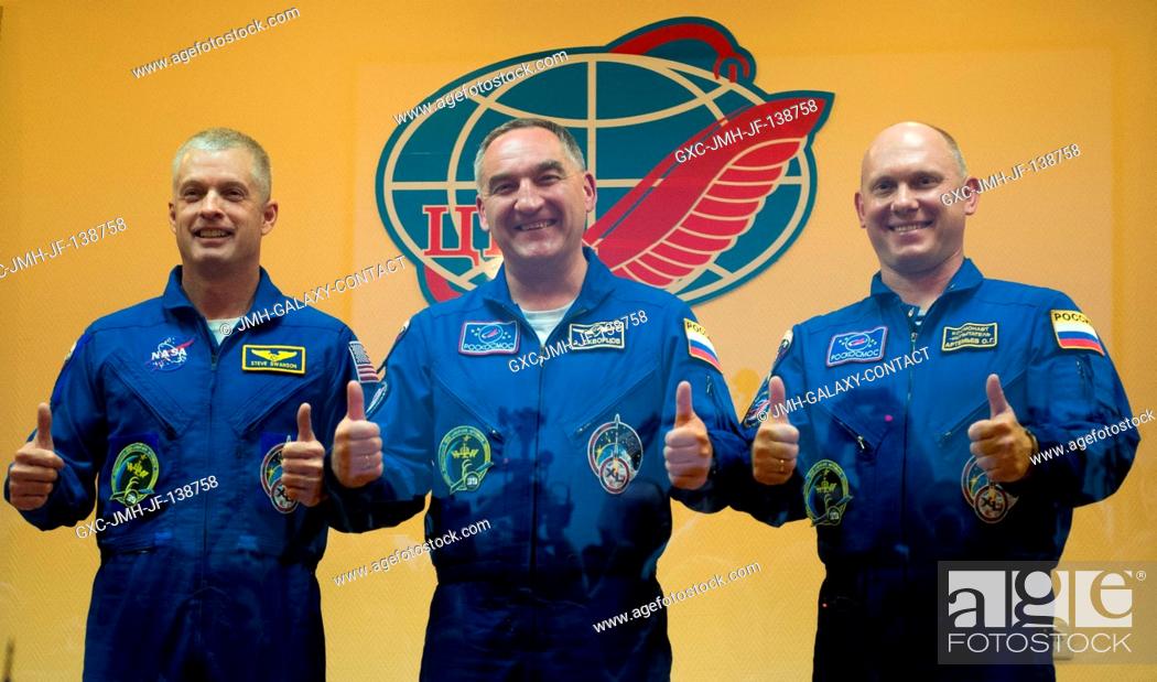Stock Photo: From the left, Expedition 39 Flight Engineer Steve Swanson of NASA, Soyuz commander Alexander Skvortsov of the Russian Federal Space Agency, (Roscosmos).