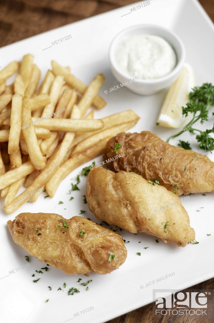 Stock Photo: british traditional fish and chips meal on wood table.