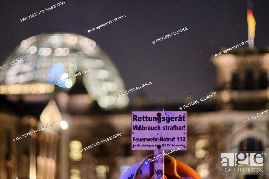 Stock Photo: 24 March 2021, Berlin: A sign with the inscription ""Rescue equipment abuse punishable! Fire emergency call 112"" stands on the Marschallbrücke.