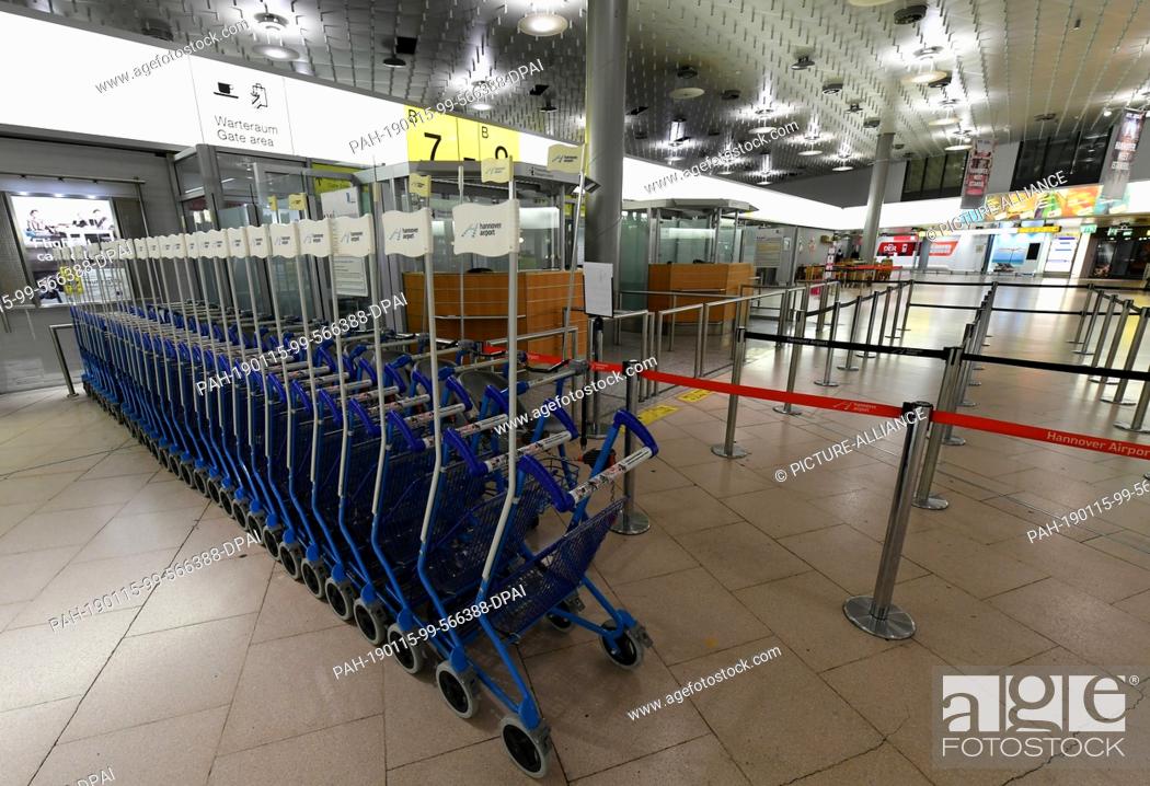 Stock Photo: 15 January 2019, Lower Saxony, Hannover: The passenger control desks in front of which baggage carts are lined up are orphaned in Departure Hall B at the.