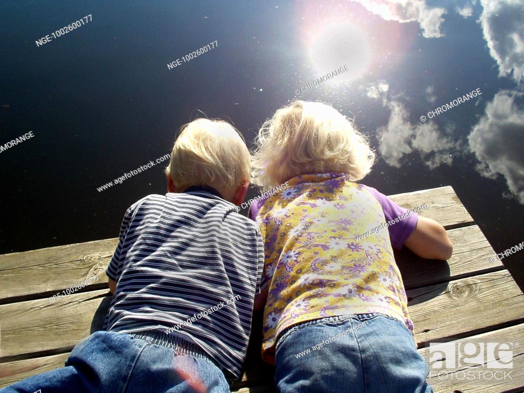 Stock Photo: Children are looking into a lake.