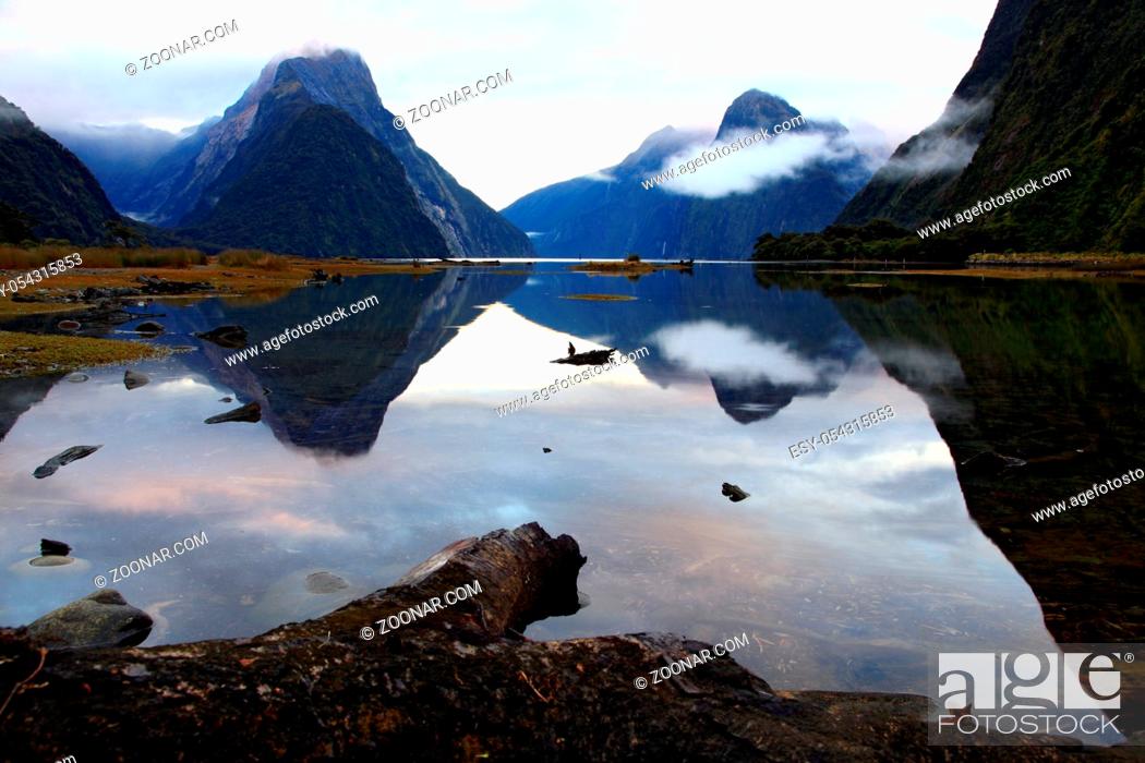 Stock Photo: reflection of high mountain glacier at milford sound, New Zealand.