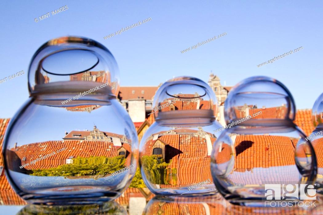 Stock Photo: Rooftops viewed through glass jars, Malmo, Sweden.