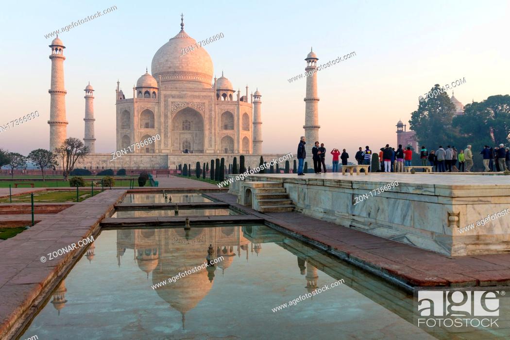 Stock Photo: Taj Mahal and its water channel reflection. A classic, winter morning view of the mausoleum lit by the soft, pastel rays of the sun rising from the right-hand.