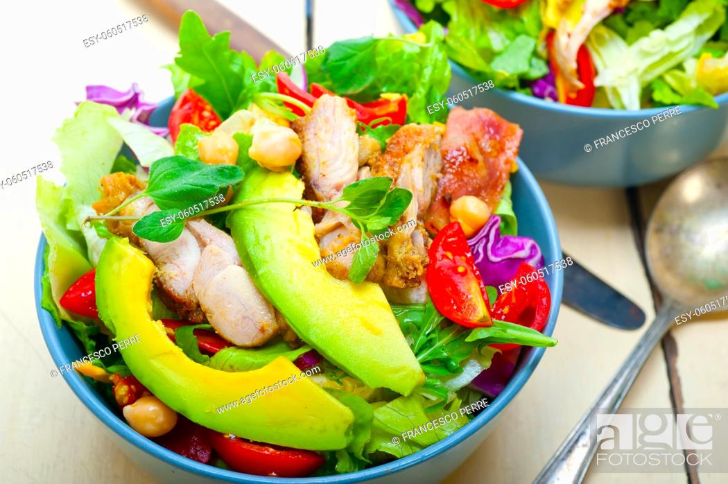 Stock Photo: fresh and healthy Chicken Avocado salad over rustic wood table.