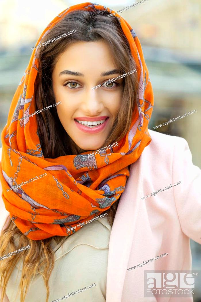 Stock Photo: Close up portrait of a muslim young woman wearing a head scarf, indoor.