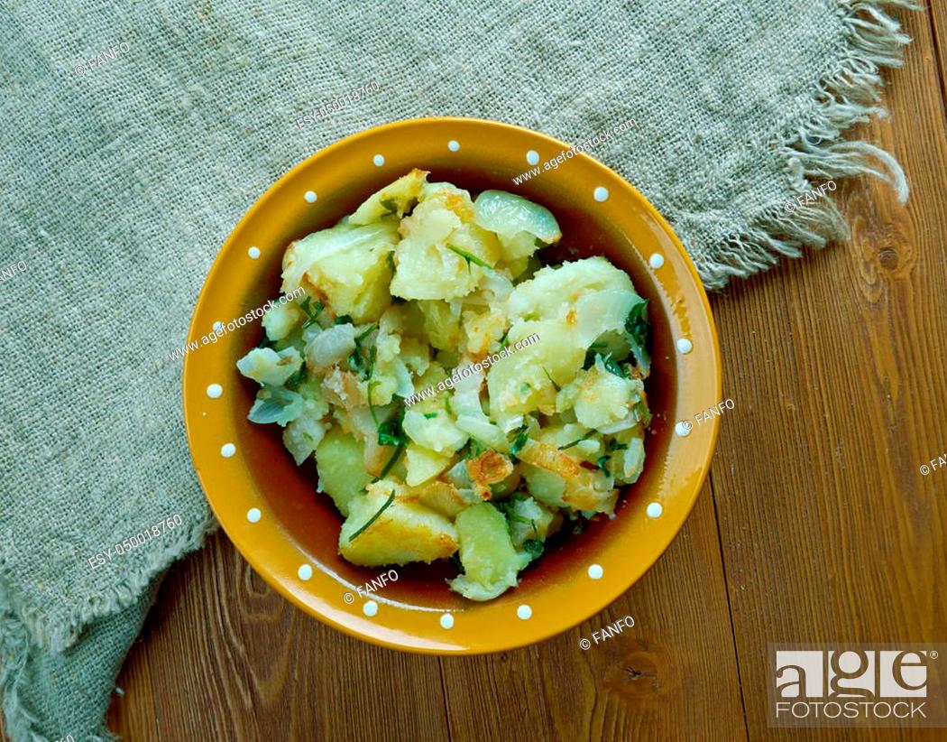 Stock Photo: Tushanka- Belarusian potato stew on a wooden background.