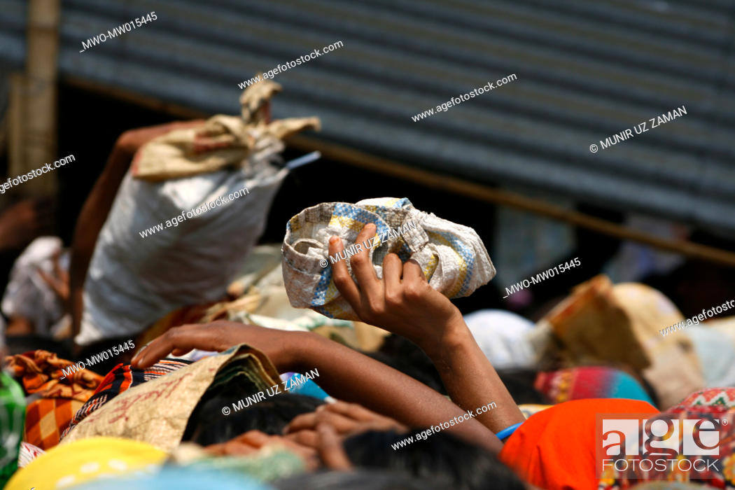 Stock Photo: People from low income group crowd at a fair price shop, run by Bangladesh Rifles or BDR, to collect rice Global rice stock has reached the lowest in the last.
