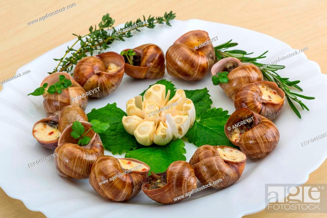 Stock Photo: Escargot with rosemary, thyme, garlik and melissa.