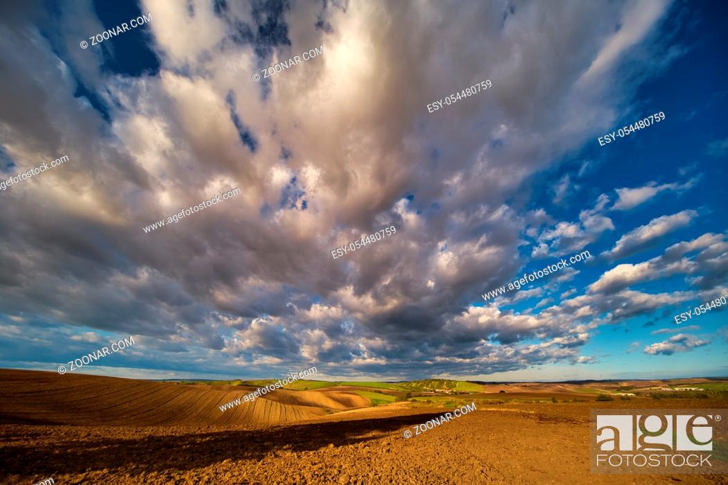 Stock Photo: Rolling fields of South Moravia in the autumn morning with a sky full of fast-moving clouds after a storm, Moravian Tuscany, Czechia.