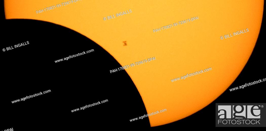 Stock Photo: HANDOUT - The International Space Station, with a crew of six onboard, is seen in silhouette as it transits the Sun at roughly five miles per second during a.