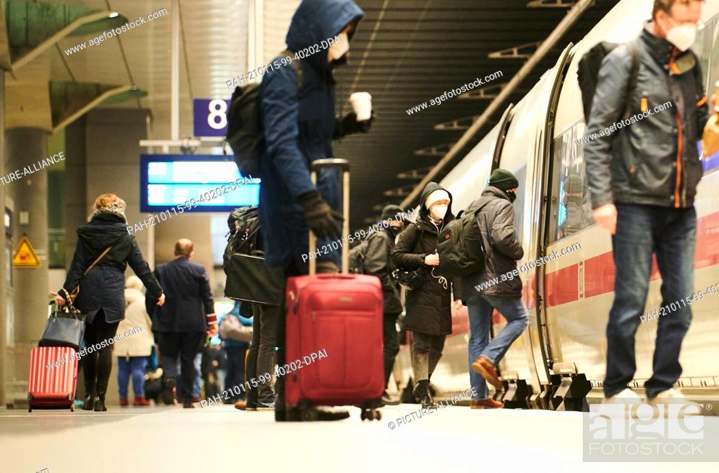 Stock Photo: 15 January 2021, Berlin: At the main station, passengers arrive at the ICE with suitcases and luggage. People in counties with an incidence of more than 200.