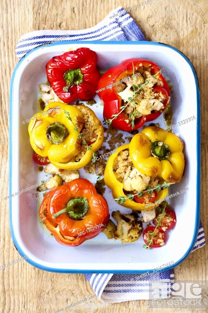 Stock Photo: Peppers filled with couscous, cauliflower and cherry tomatoes.